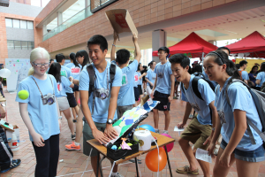 Ebenezer School student Ellie Tang actively promotes her game booth at the fun fair of Leadership and Innovation Summer Camp